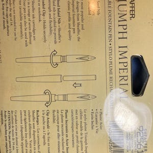 May include: A gold Sheaffer Triumph Imperial fountain pen with a stainless steel inlaid nib. The pen features a spring-loaded clip and is refillable with Sheaffer ink cartridges. The packaging includes a lifetime guarantee and a gift box.