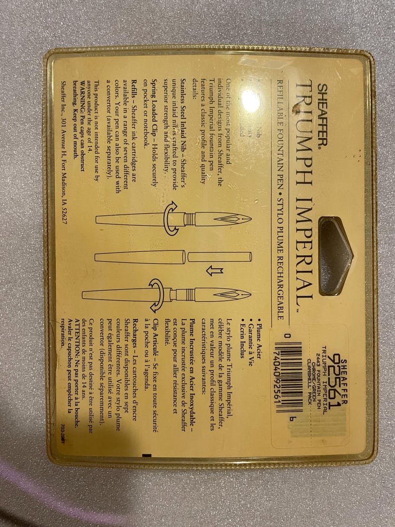 May include: A gold Sheaffer Triumph Imperial fountain pen with a chrome finish and green accents. The pen features a classic design with a stainless steel inlaid nib, a spring-loaded clip, and a refillable ink cartridge system. The packaging includes a pen case.