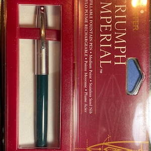 May include: A green and silver Sheaffer Triumph Imperial refillable fountain pen in its original box. The box is red with gold lettering and a drawing of a pen nib.