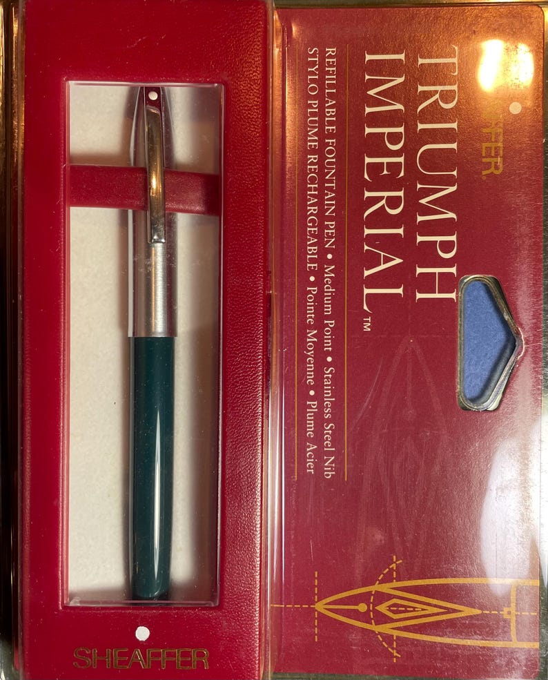 May include: A green and silver Sheaffer Triumph Imperial refillable fountain pen in its original box. The box is red with gold lettering and a drawing of a pen nib.