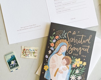 Pode incluir: Um cartão preto com uma inscrição dourada que diz "Um Bouquet Espiritual para Você". O cartão apresenta uma ilustração colorida da Virgem Maria segurando um bebê Jesus. A ilustração é cercada por flores.