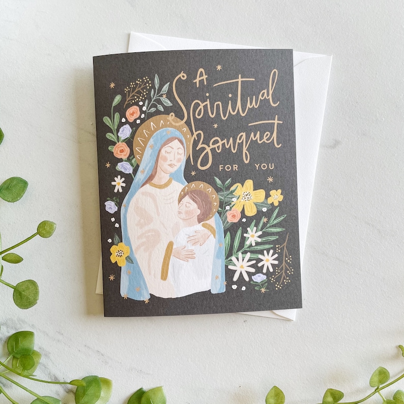 May include: A black card with a floral design and a painting of Mary and Jesus. The text reads "A Spiritual Bouquet For You".