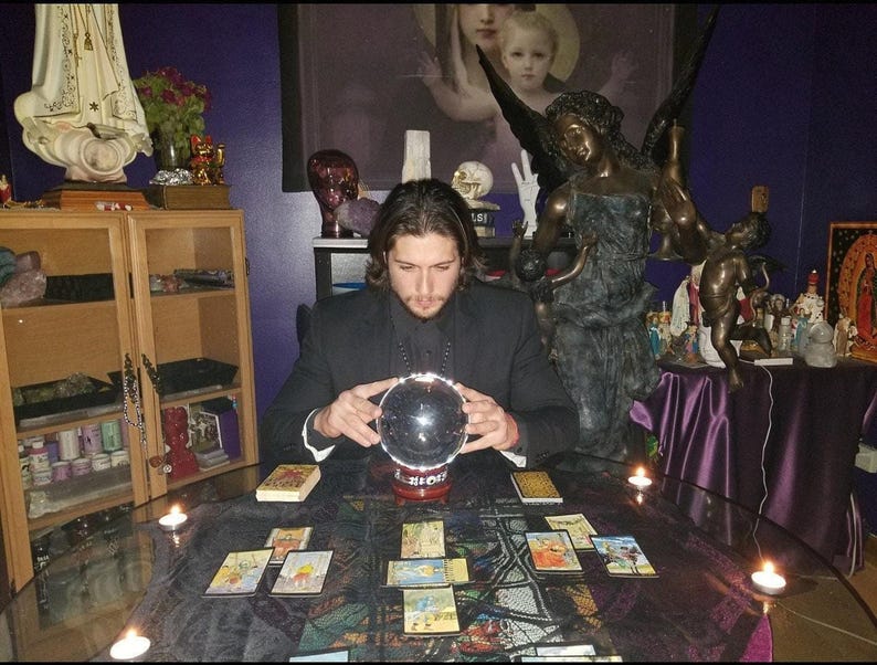 Psychic Derrek performing a tarot card reading at a candlelit altar table with crystals, offering a written PDF report digital download.