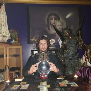 Psychic reader Derrek channeling intuitive guidance over a spread of tarot cards and glowing crystals for a written report in PDF format.