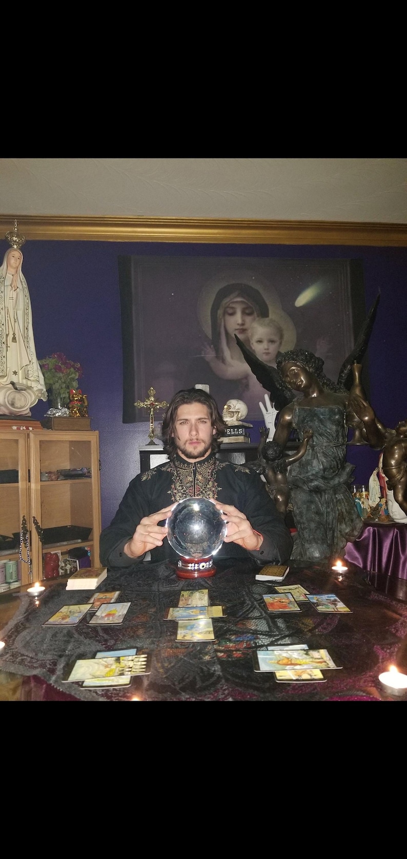 Psychic reader Derrek channeling intuitive guidance over a spread of tarot cards and glowing crystals for a written report in PDF format.