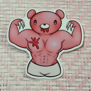 May include: A pink sticker featuring a muscular bear with sharp claws and a bloody mouth. The bear has a white outline and is flexing its arms, showcasing its defined chest and abs. The bear is wearing white shorts.