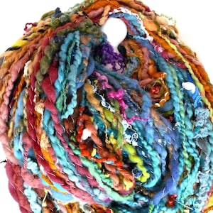 May include: A colorful ball of yarn with a variety of textures and colors, including blue, green, orange, and red.