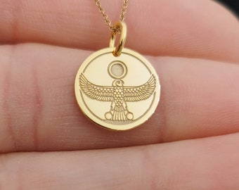 May include: Gold necklace with a round pendant featuring an engraved image of the Egyptian goddess,  the winged sun disk, known as the "Winged Sun of Ra".