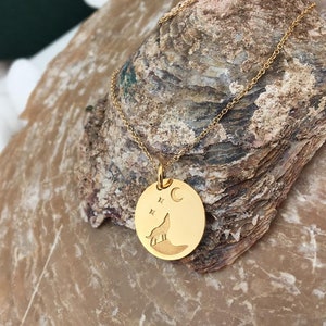 Wolf necklace engraved, circular,
solid gold pendant 14k,
the size is 0,5 iches / 12,7 millimeter.
Thickness 0,5 milimiters.
The hoop on top is circular and gold as well.
 The finish of the pendant in shinny.