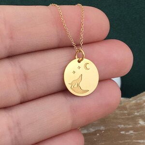 Wolf necklace engraved, circular,
solid gold pendant 14k,
the size is 0,5 iches / 12,7 millimeter.
Thickness 0,5 milimiters.
The hoop on top is circular and gold as well.
 The finish of the pendant in shinny.