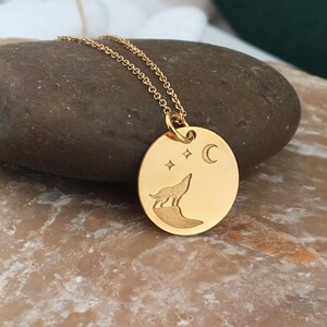 Wolf necklace engraved, circular,
solid gold pendant 14k,
the size is 0,5 iches / 12,7 millimeter.
Thickness 0,5 milimiters.
The hoop on top is circular and gold as well.
 The finish of the pendant in shinny.