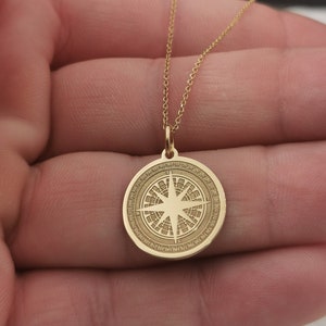 Compass engraved, circular,
solid gold pendant 14k,
the size is 0,75 iches / 19,1 millimeter.
Thickness 0,5 milimiters.
The hoop on top is circular and gold as well.
 The finish of the pendant in shinny.