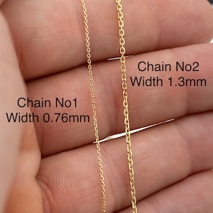 May include: Two gold-colored chain necklaces are displayed, with Chain No1 measuring 0.76mm in width and Chain No2 measuring 1.3mm. The chains are shown against a neutral background, highlighting their delicate links and warm metallic hue. The image focuses on the chain's design.