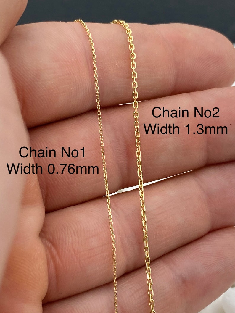 May include: Two gold-colored chain necklaces are displayed, with Chain No1 measuring 0.76mm in width and Chain No2 measuring 1.3mm. The chains are shown against a neutral background, highlighting their delicate links and warm metallic hue. The image focuses on the chain's design.