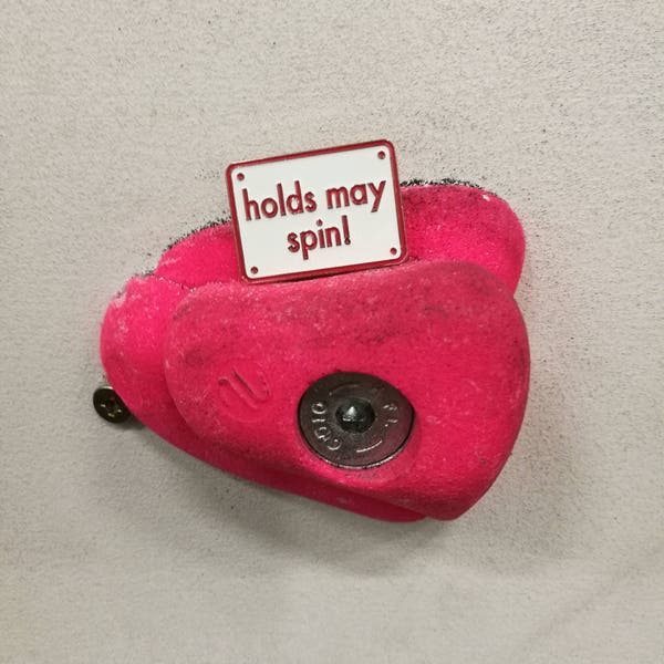 Holds may spin: climbing pin badge