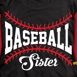 May include: Black t-shirt with white text that says "Baseball Sister" with a red baseball stitch design.