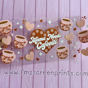 May include: A clear sticker sheet with coffee cups, hearts, and the text "Mama Needs Cafecito." The coffee cups are brown and pink with floral designs. Hearts and star shapes are scattered around the design.