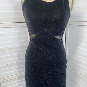 May include: A black sparkly sleeveless mini dress with a mesh panel at the waist.