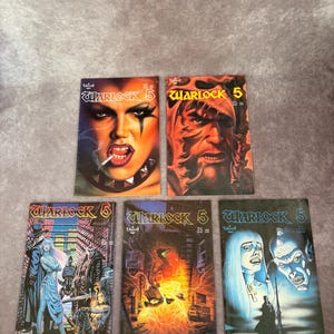May include: Five Warlock 5 comic books featuring various cover art. The top left cover shows a person with dark makeup and a cigarette. The top right cover depicts a bearded figure. The bottom covers feature illustrated scenes with characters.