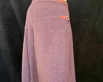 May include: A long, purple and white plaid skirt with a wrap-around design and two leather buckles on the side.
