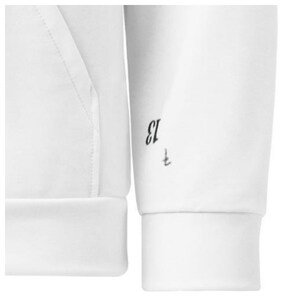 May include: Close-up of a white hoodie sleeve with a ribbed cuff. The number "13" and a small symbol are printed in black near the cuff. The hoodie's hood and pocket are visible on the left side.