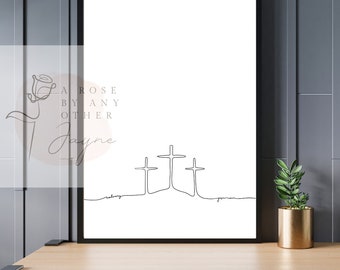 May include: A black and white line art print of three crosses with the text "A rose by any other" and "Jayne" below the crosses.