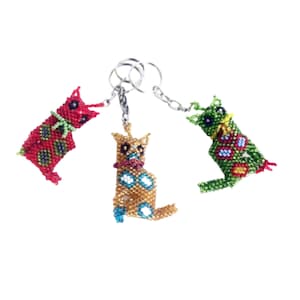 May include: Three beaded cat keychains with colourful patterns. The cats are red, green, and gold with black, white, and blue accents. The keychains are attached to silver key rings.