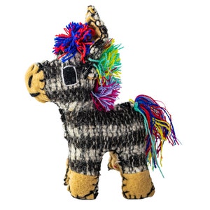 May include: A black and white striped stuffed toy horse with a colorful mane and tail. The horse has a black eye and a brown nose.