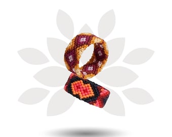 May include: Two woven rings made of colorful thread. The top ring features a diamond pattern in shades of burgundy, light pink, and golden yellow. The bottom ring displays a geometric pattern in black, bright orange, and deep red tones.