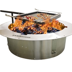 May include: A stainless steel fire pit with a grill grate over a bed of burning coals. The grill grate is raised above the fire pit using a metal handle.