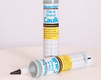 May include: Two tubes of Color Fast Tile & Grout Caulk, a silicone-based acrylic sealant. The tubes are green and white with black caps. The text on the tubes reads "Color Fast Tile & Grout Caulk" and "Siliconized Acrylic".
