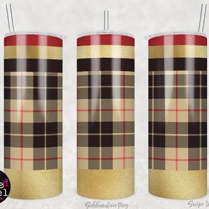 May include: Three stainless steel tumblers with a gold glitter bottom and a plaid pattern in black, beige, and red. The tumblers have a red top and a clear lid.