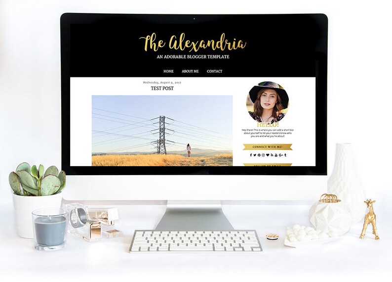 Puede incluir: Una pantalla de ordenador muestra una plantilla de sitio web llamada "The Alexandria" en negro y dorado. La pantalla muestra una entrada de blog con una foto de una mujer y un paisaje. Un teclado y accesorios de escritorio est&aacute;n en primer plano.
