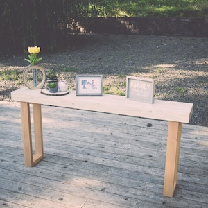 Bleached white console table with rectangular legs