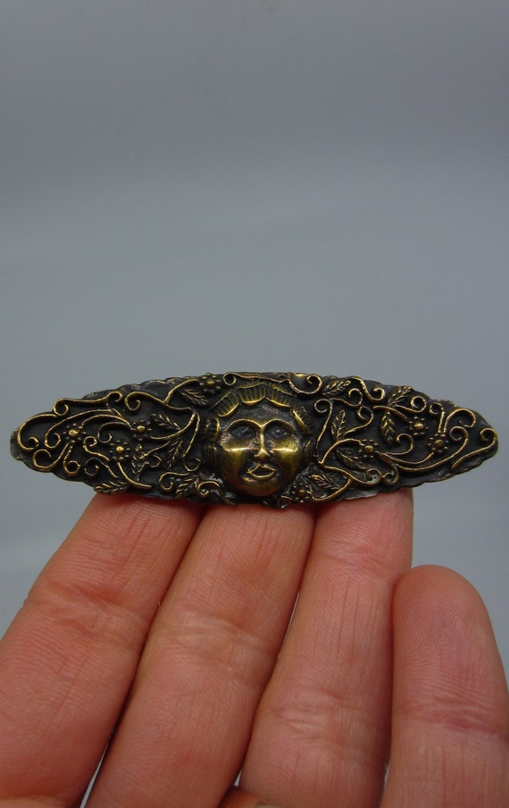 Large antique metal brooch with round face mascaro