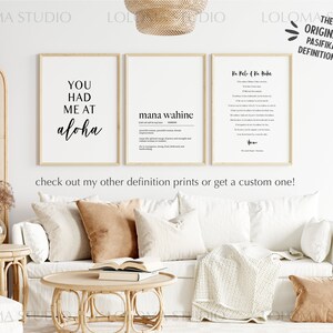 May include: Three framed prints with white backgrounds and black text. The prints are hanging on a white wall. The left print says "You had me at aloha". The middle print says "mana wahine" and has a definition below. The right print says "Ke Pele o Na Haku" and has a definition below. The prints are part of a collection called "The Original Pasifika Definitions".