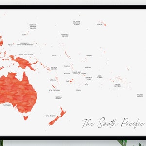 May include: A framed print showing a watercolour map of the South Pacific. The landmasses are depicted in orange hues against a white backdrop. The title "The South Pacific" is written in elegant script.