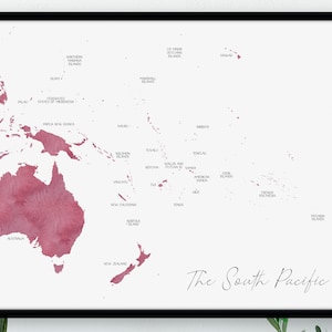 May include: A framed print showing a map of the South Pacific, rendered in a watercolour style with red and pink hues on a white backdrop. The map includes country names and the title "The South Pacific."