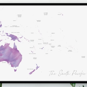 May include: A framed map of the South Pacific, with a watercolour design in purple and pink hues. The map shows countries and islands, each labelled. The words "The South Pacific" are written in a cursive font.
