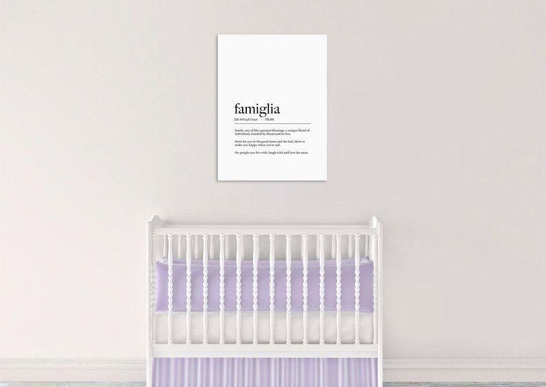 May include: A white framed print with the word "famiglia" in black text, defined as "family, one of life's greatest blessings, a unique blend of individuals, bonded by natural instinct and love. There for you in the good times and the bad, there to make you happy when you're sad. The people you love with, laugh with and love the most."