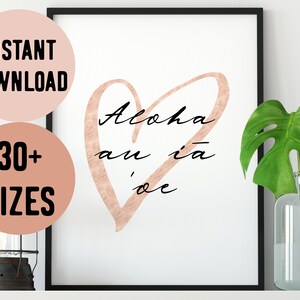 May include: A printable wall art design featuring a rose gold heart with the text "Aloha au ia oe" in black calligraphy.