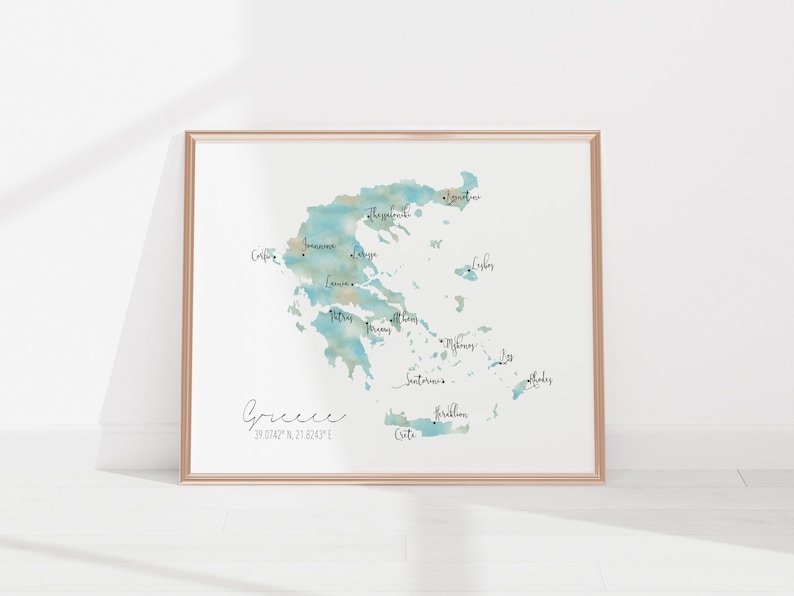 May include: A watercolor map of Greece with the names of major islands and cities labeled in black script. The map is framed in a light brown frame. The coordinates for Greece are listed below the word "Greece" in black script.