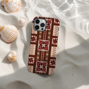 May include: A smartphone case with a geometric pattern in shades of brown, red, and beige. The case features a repeating design of floral and triangular shapes. The case is resting on white sand, with seashells scattered around.
