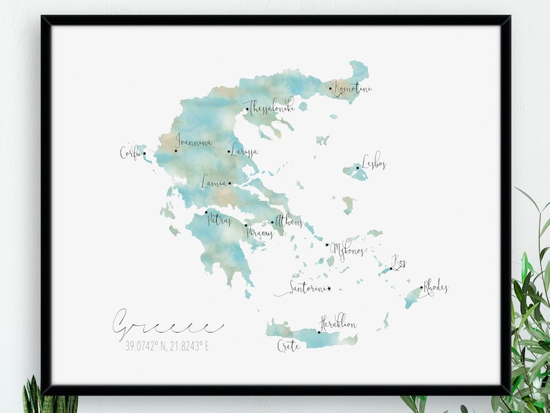 May include: A watercolor map of Greece with the names of major cities and islands labeled. The map is in shades of blue and beige, with a white background. The text "Greece 39.0742&deg; N, 21.8243&deg; E" is at the bottom of the map.