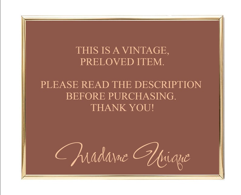 May include: A brown sign with gold trim, reading "This is a vintage, preloved item. Please read the description before purchasing. Thank you!" with the signature "Madame Unique" in cursive.