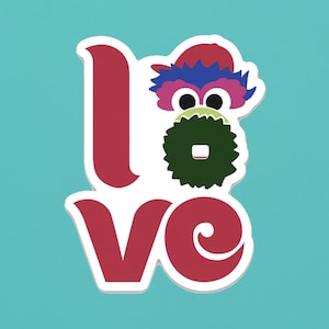 May include: A red, white, and blue monster wearing a red hat and holding a green wreath with the word "LOVE" in red letters.