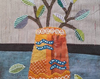 hand stitched applique still life of plant in an orange pot.