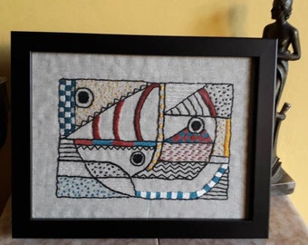 Abstract textile art picture in black wood frame.