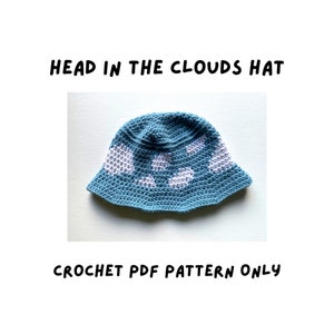 May include: A crochet pattern for a blue and white hat with a cloud design. The pattern is called "Head in the Clouds Hat" and is available as a PDF download.