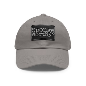 May include: A gray baseball cap with a black patch that says "Sponge Worthy?" in white text.